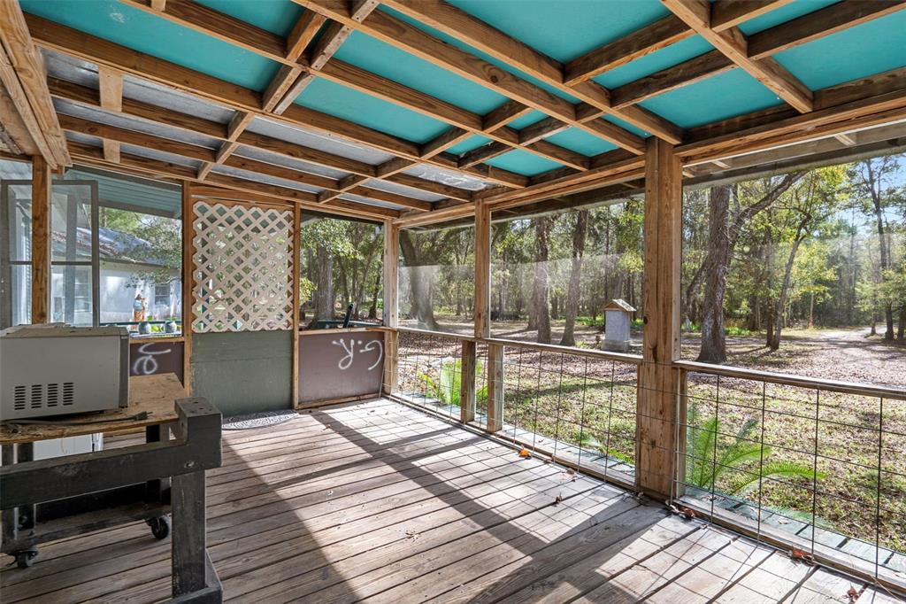 22439 Bull Run Road Brooksville, FL 34602 - Photo 13 of 66 a balcony with wooden floor