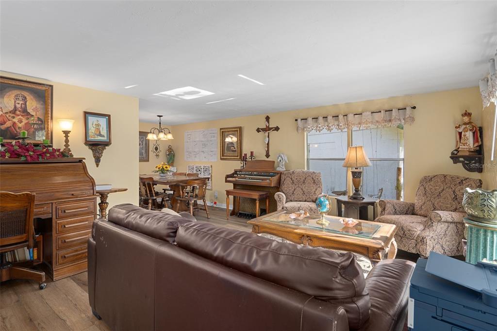 22439 Bull Run Road Brooksville, FL 34602 - Photo 15 of 66 a living room with furniture and a fireplace