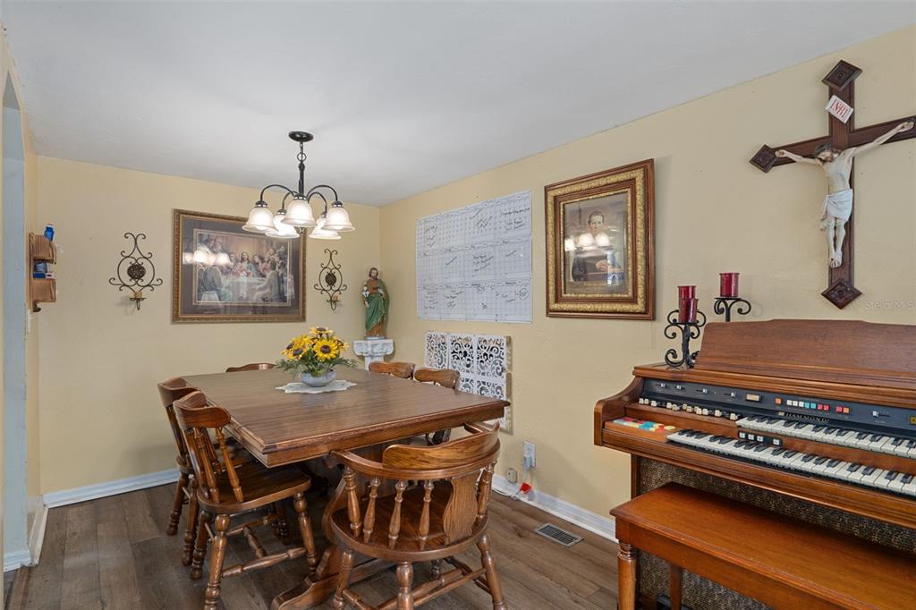 22439 Bull Run Road Brooksville, FL 34602 - Photo 18 of 66 a view of a dining room with furniture and chandelier