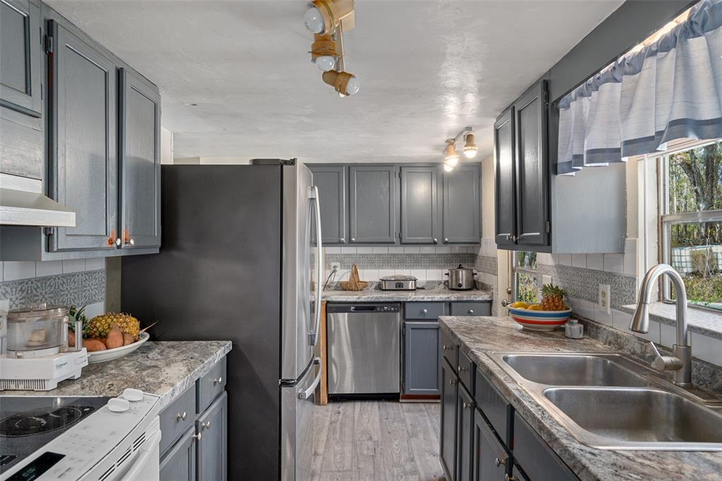 22439 Bull Run Road Brooksville, FL 34602 - Photo 20 of 66 a kitchen with a sink stove and refrigerator