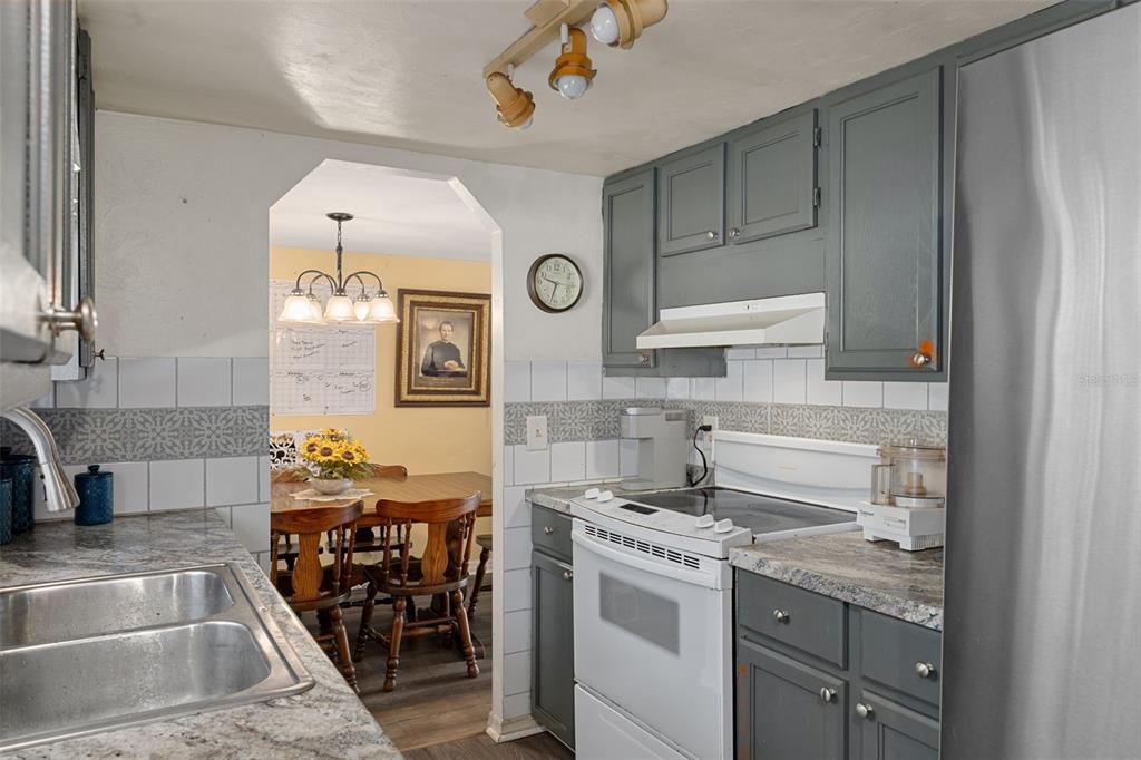 22439 Bull Run Road Brooksville, FL 34602 - Photo 22 of 66 a kitchen with stainless steel appliances granite countertop a stove and a sink