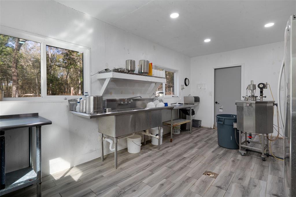 22439 Bull Run Road Brooksville, FL 34602 - Photo 49 of 66 a living room with furniture and a wooden floor