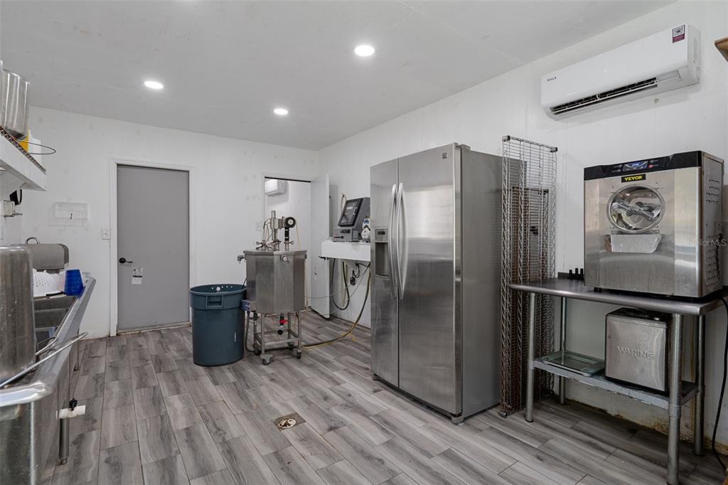 22439 Bull Run Road Brooksville, FL 34602 - Photo 50 of 66 a kitchen with stainless steel appliances a refrigerator and wooden floor