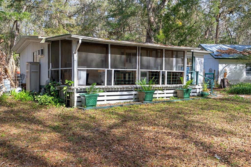 22439 Bull Run Road Brooksville, FL 34602 - Photo 7 of 66 a view of a house with a yard and large trees