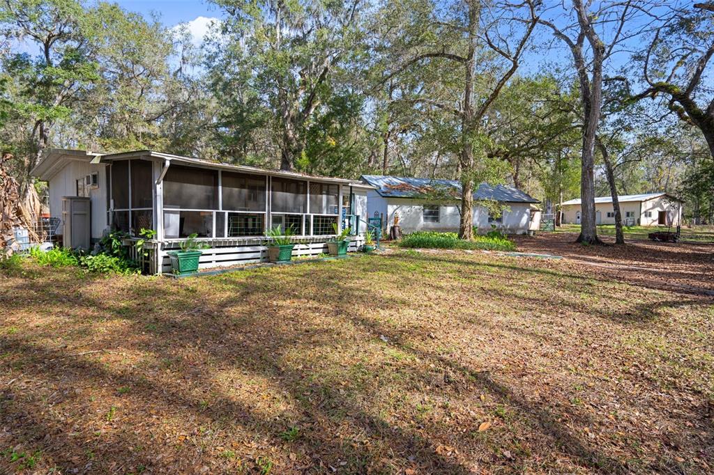 22439 Bull Run Road Brooksville, FL 34602 - Photo 8 of 66 a front view of a house with a yard and trees