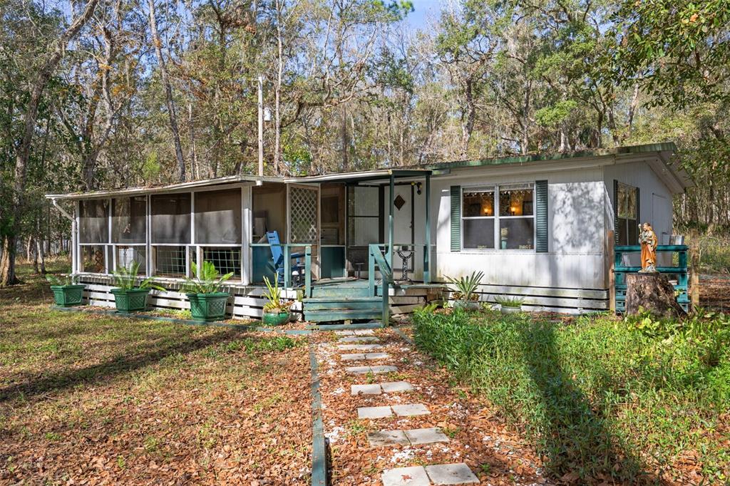 22439 Bull Run Road Brooksville, FL 34602 - Photo 9 of 66 a front view of a house with garden