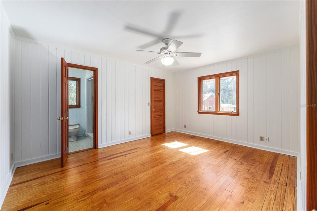 22157 Northwest 87th Avenue Road Micanopy, FL 32667 - Photo 11 of 34 a view of empty room with wooden floor