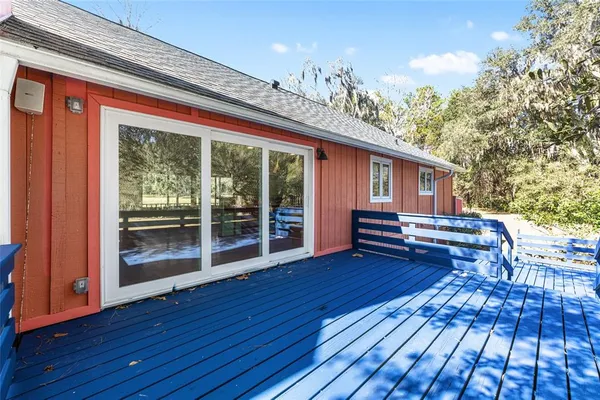 a view of wooden floor and bench in a yard