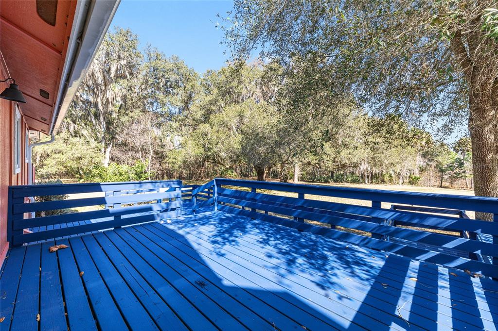 22157 Northwest 87th Avenue Road Micanopy, FL 32667 - Photo 15 of 34 a view of wooden floor and bench in a yard
