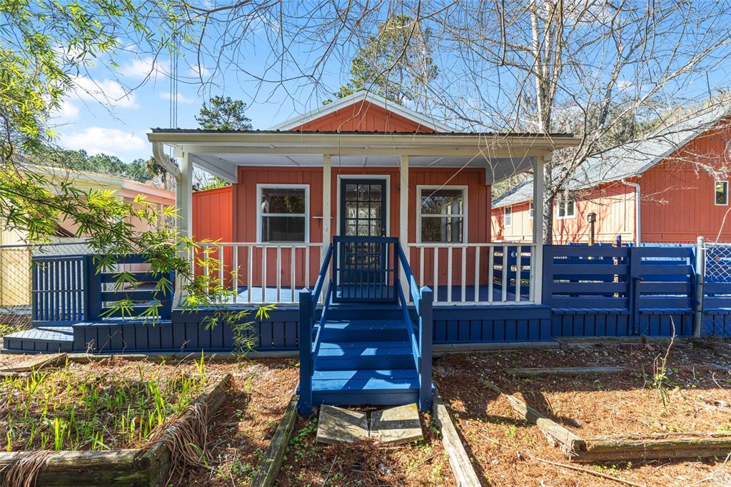 22157 Northwest 87th Avenue Road Micanopy, FL 32667 - Photo 19 of 34 a view of a house with wooden floor next to a yard