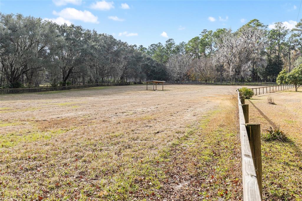 22157 Northwest 87th Avenue Road Micanopy, FL 32667 - Photo 26 of 34 a view of a yard with wooden fence