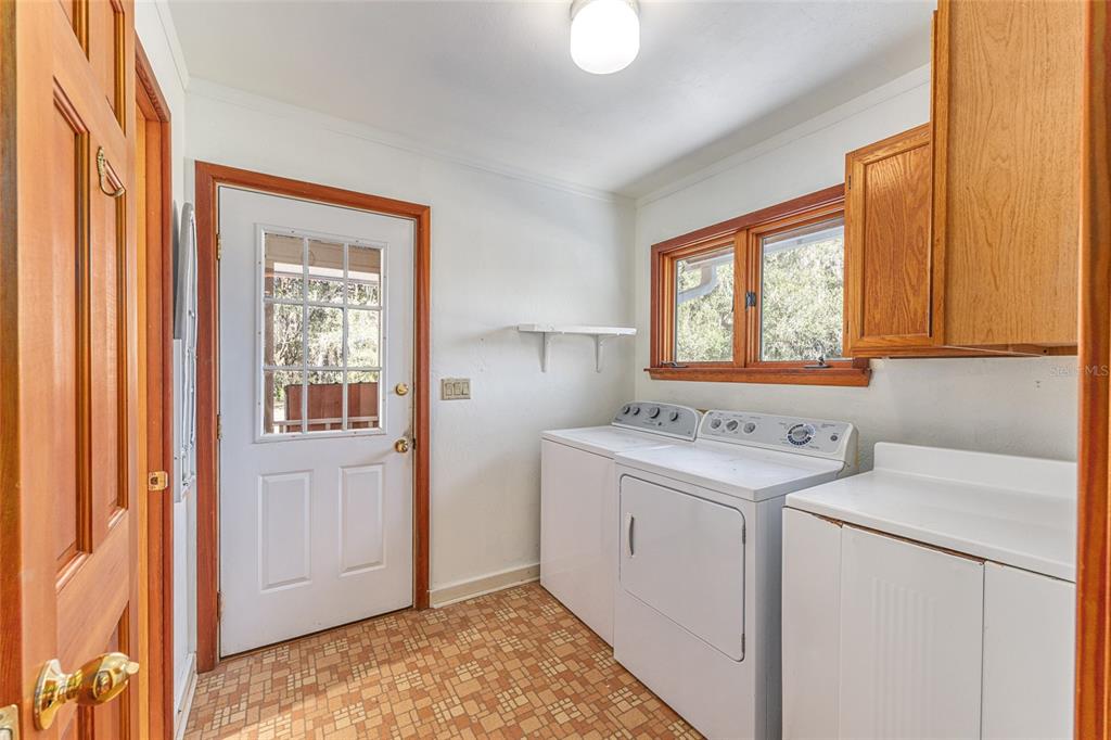 22157 Northwest 87th Avenue Road Micanopy, FL 32667 - Photo 8 of 34 a view of hallway with washer and dryer