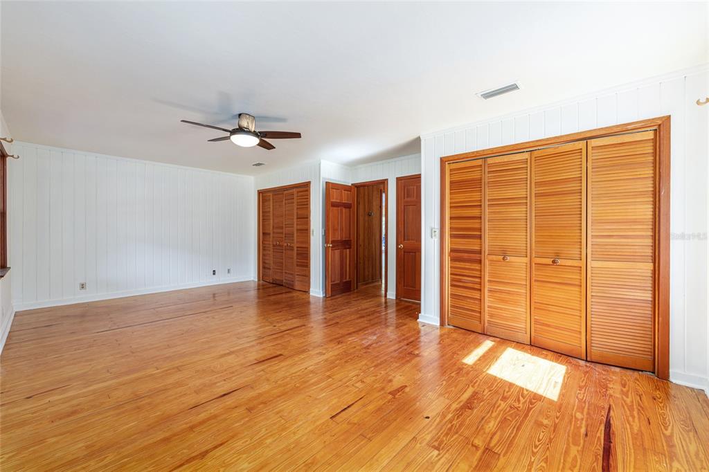 22157 Northwest 87th Avenue Road Micanopy, FL 32667 - Photo 9 of 34 wooden floor in an empty room with a window