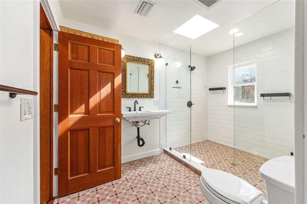 22157 Northwest 87th Avenue Road Micanopy, FL 32667 - Photo 10 of 34 a bathroom with a sink a toilet and shower