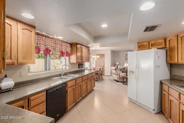 a kitchen with stainless steel appliances a refrigerator sink and cabinets