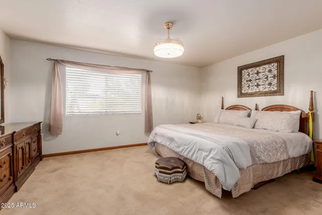 a spacious bedroom with a bed and a window
