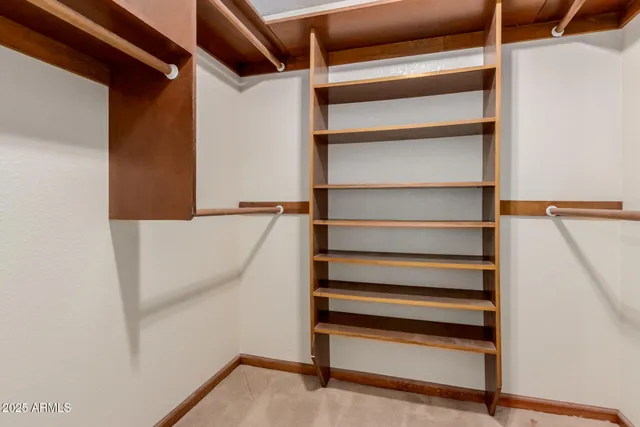 a view of walk in closet with empty racks