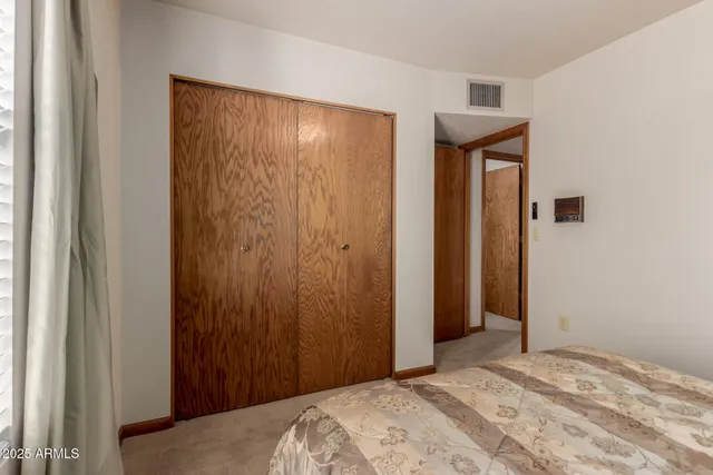 a bed room with two beds and a chair