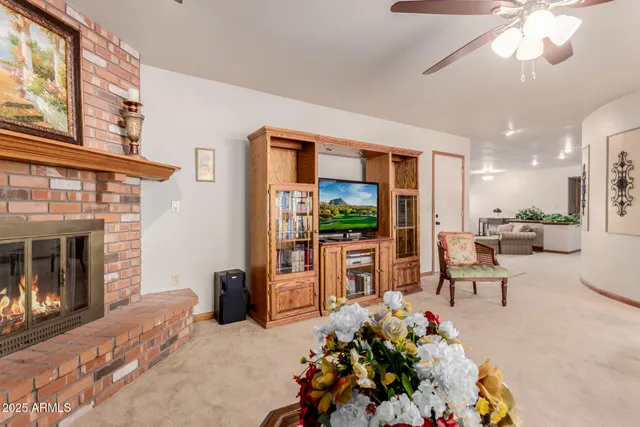 a living room with furniture a fireplace and a flat screen tv
