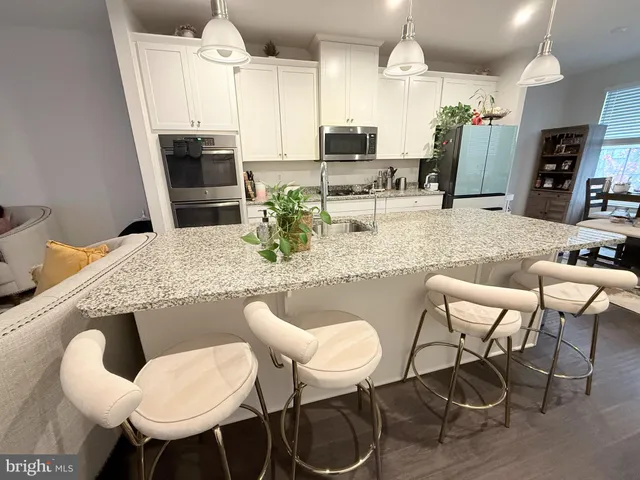 a dining room with furniture and a kitchen view