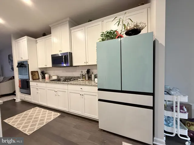 a kitchen with stainless steel appliances a refrigerator sink and microwave