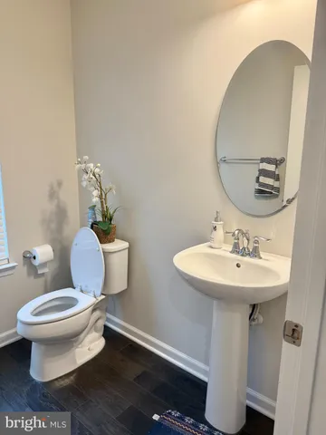 a bathroom with a toilet sink and mirror