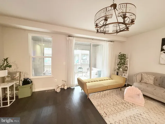 a bedroom with furniture and a large window