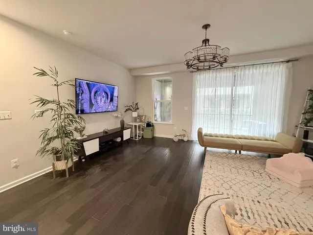 a spacious bedroom with furniture and a large window