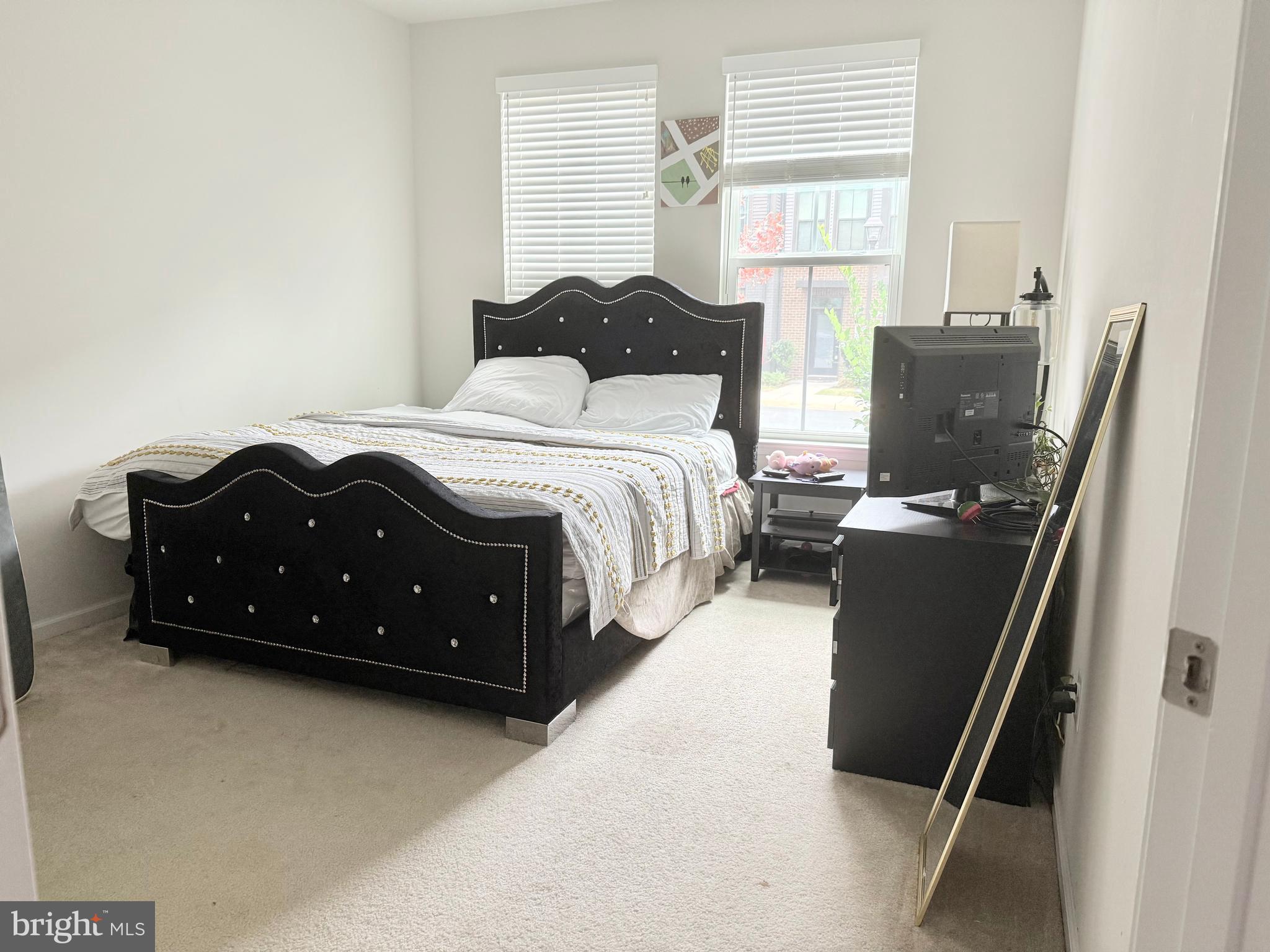 22269 Sims Terrace Ashburn, VA 20148 - Photo 28 of 44 a bedroom with a bed and wooden floor