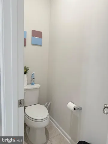a white toilet sitting next to a bathroom sink