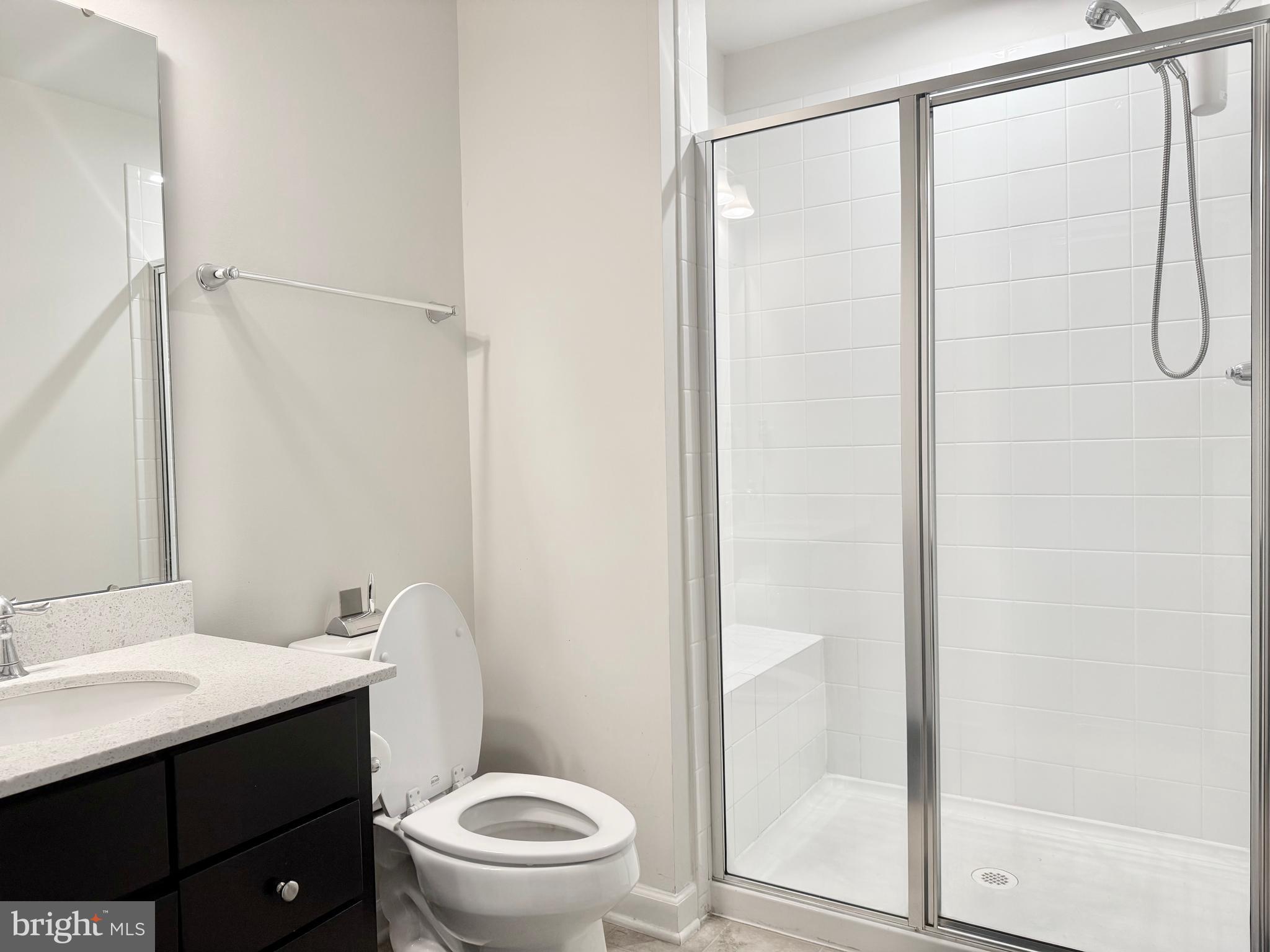 22269 Sims Terrace Ashburn, VA 20148 - Photo 37 of 44 a white toilet sitting next to a bathroom sink