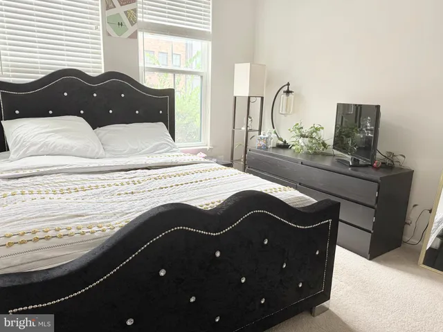 a bedroom with a bed and dresser