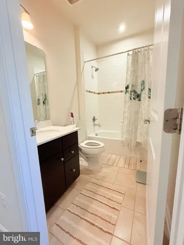 a bathroom with a double vanity sink toilet mirror and shower