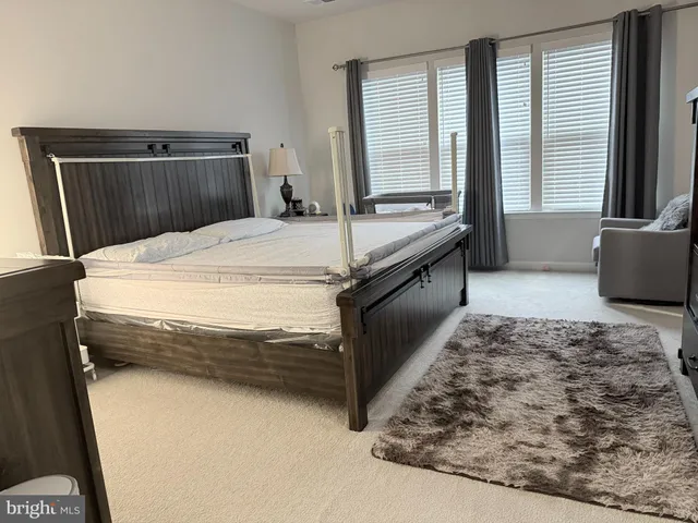 a bathroom with a tub and a view of living room