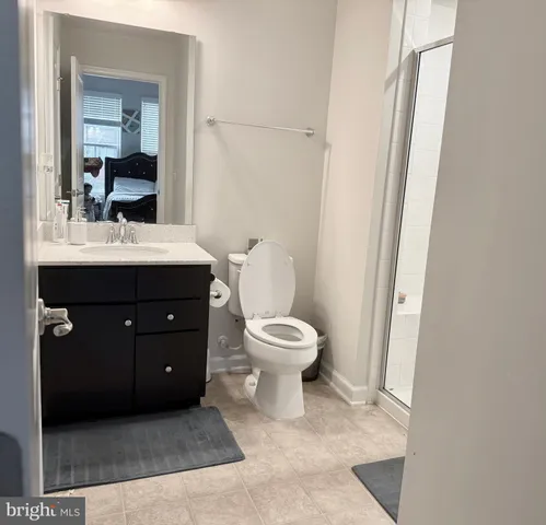 a bathroom with a sink toilet and mirror