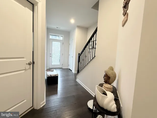 a view of entryway and hall with wooden floor