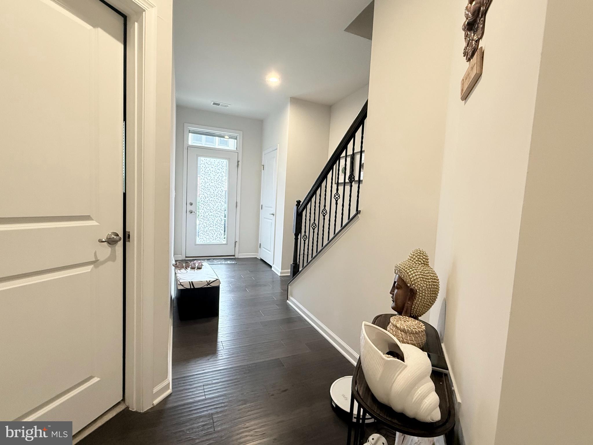 22269 Sims Terrace Ashburn, VA 20148 - Photo 8 of 44 a view of entryway and hall with wooden floor