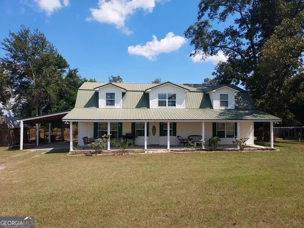 a front view of a house with swimming pool and view of house