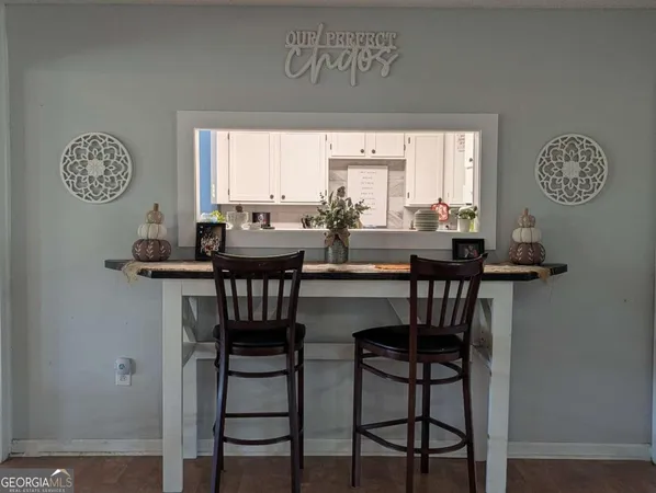 a view of a dining room with furniture and a window