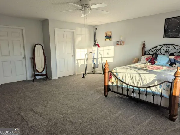 a bed sitting in a bedroom next to a window