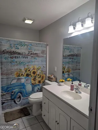 a bathroom with a sink mirror and toilet