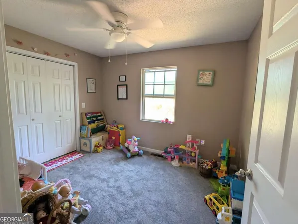 a playing room with toys and a window