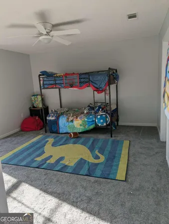 a bedroom with a bed and a wooden floor