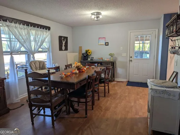 a view of a dining room with furniture and window