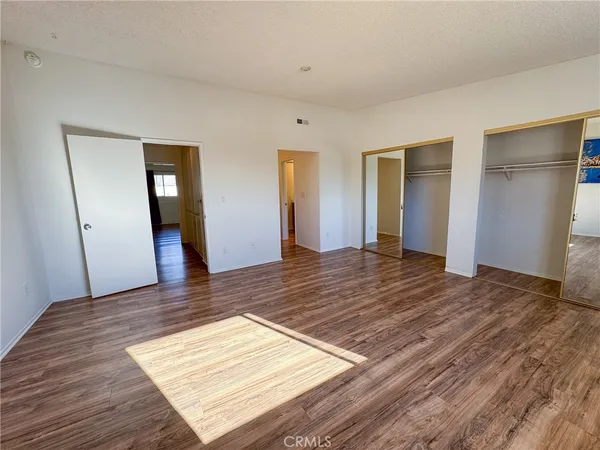 a view of a room with wooden floor and bathroom