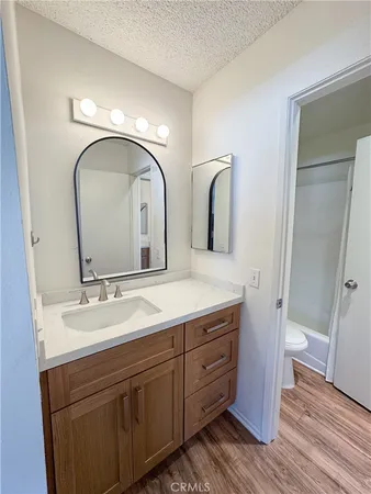 a bathroom with double vanity sink and two mirror