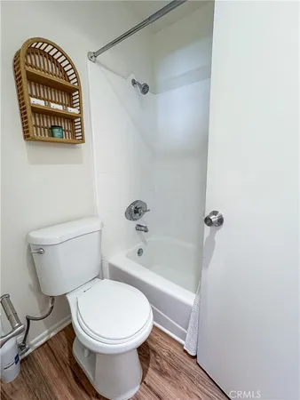 a white toilet sitting next to a bath tub shower
