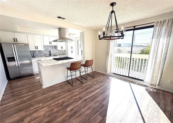 a living room with a dining table furniture a sink and appliances