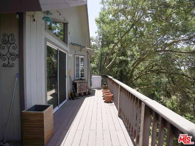 a balcony with wooden floor and fence