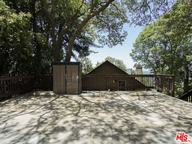 a view of a house with wooden fence